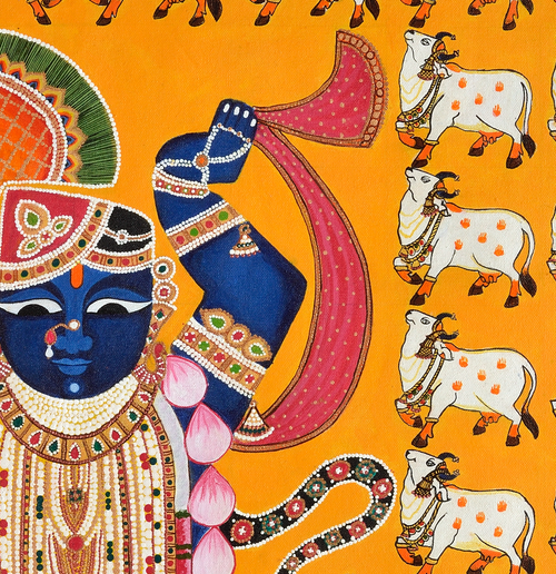 Close-up detail of intricate Pichwai patterns and hand-painted cows around Shrinathji deity figure